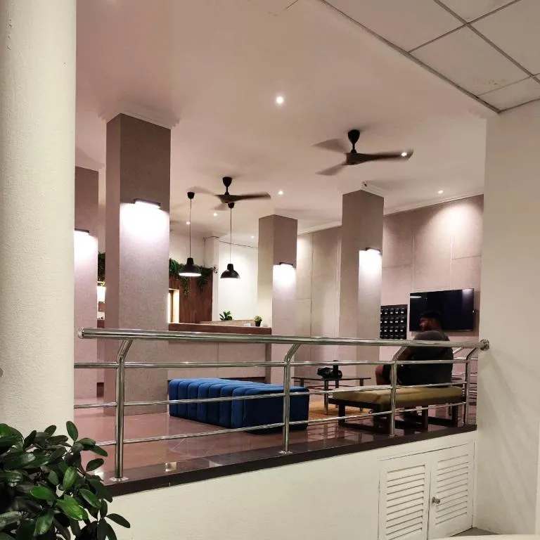 Bright, open lobby lounge with sofas and ceiling fans