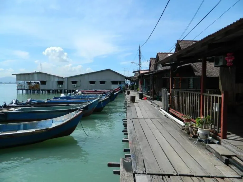Wooden walkway and boats at Chew Jetty