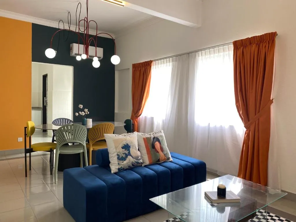 Living room with a deep-blue sofa and dining corner