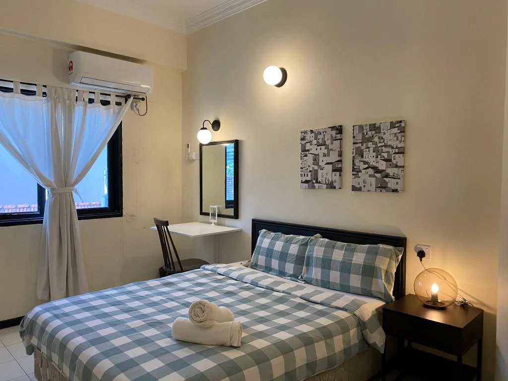 Double room with gingham bedding and soft lighting