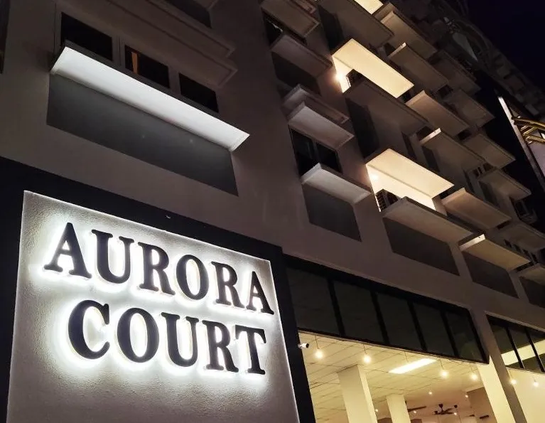 Illuminated Aurora Court sign at night