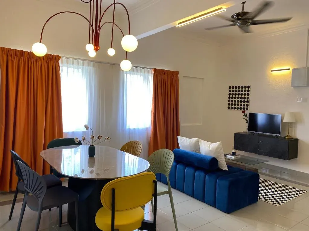 Duplex lounge and dining area with chandelier and blue sofa