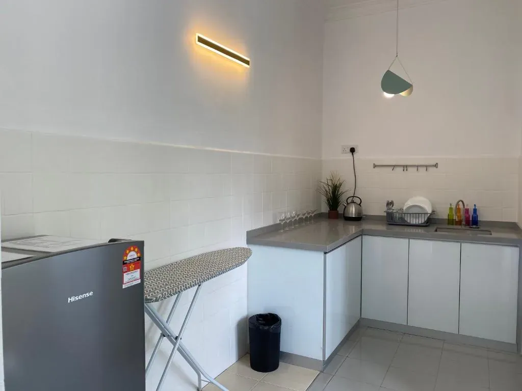 Fitted kitchen with fridge and ironing board