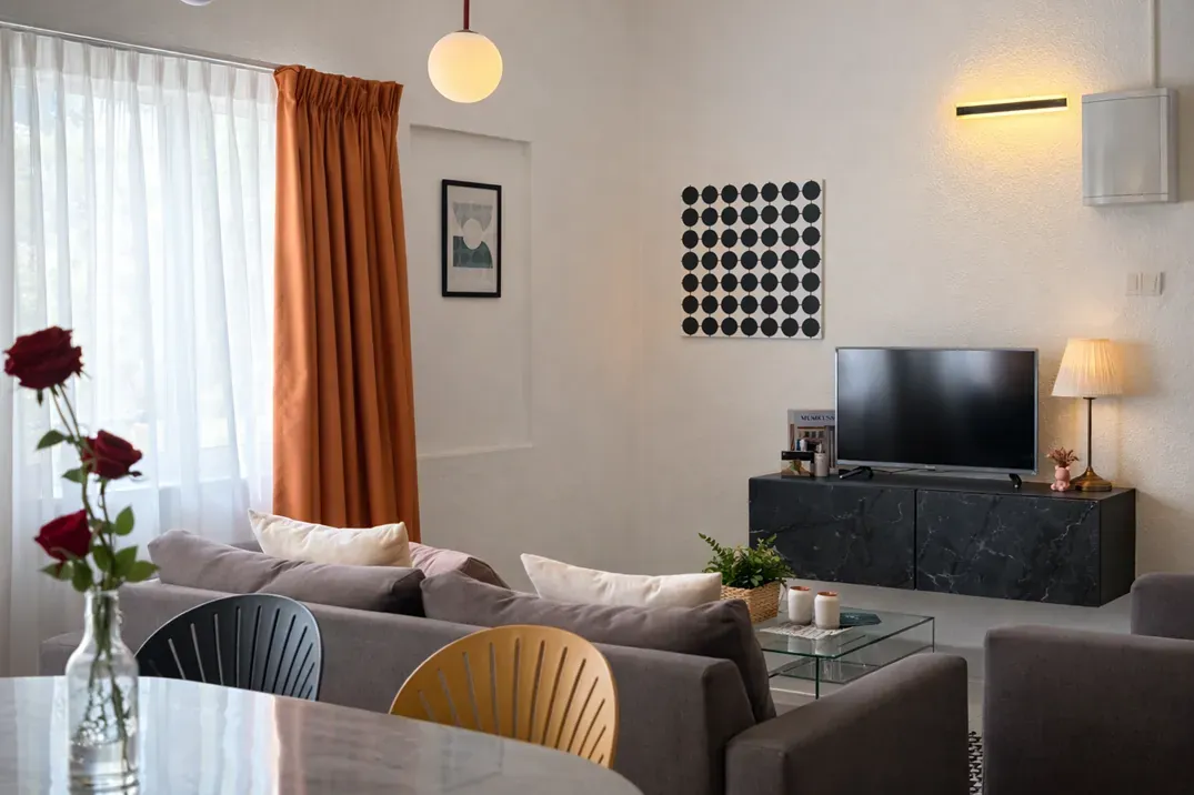 Lounge with sofa, TV and dining table