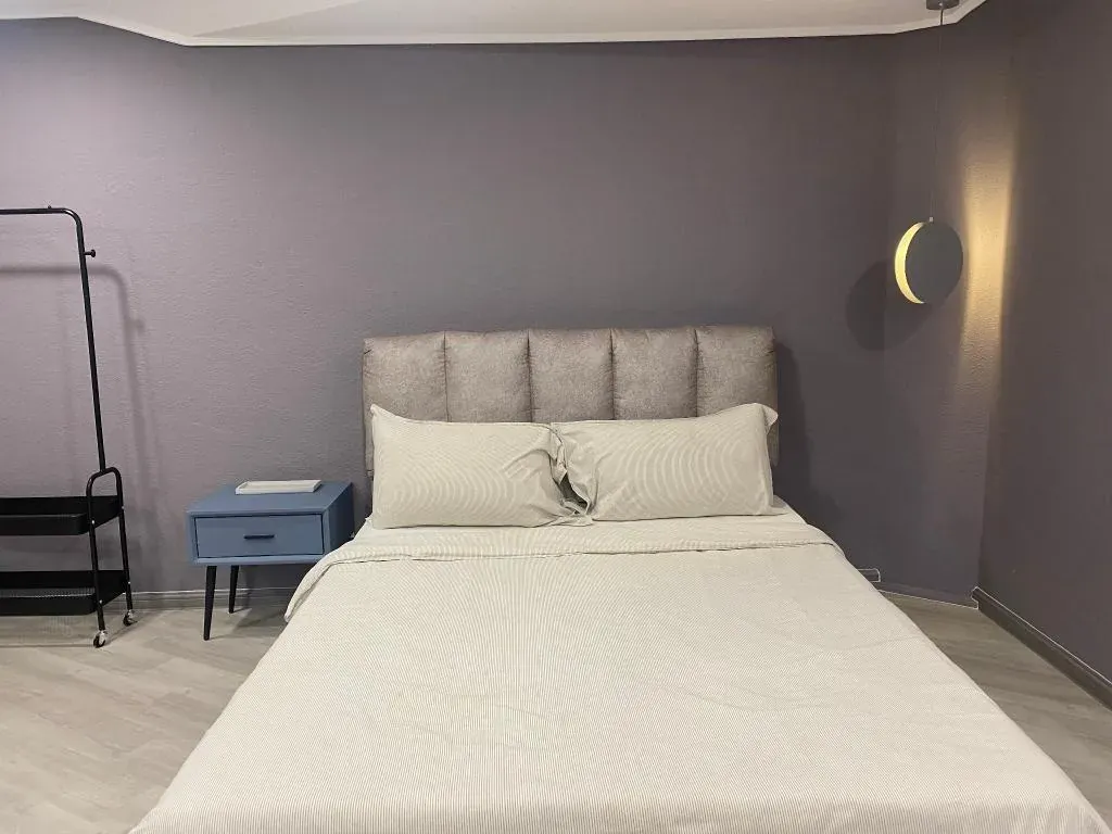 Queen bed with upholstered headboard