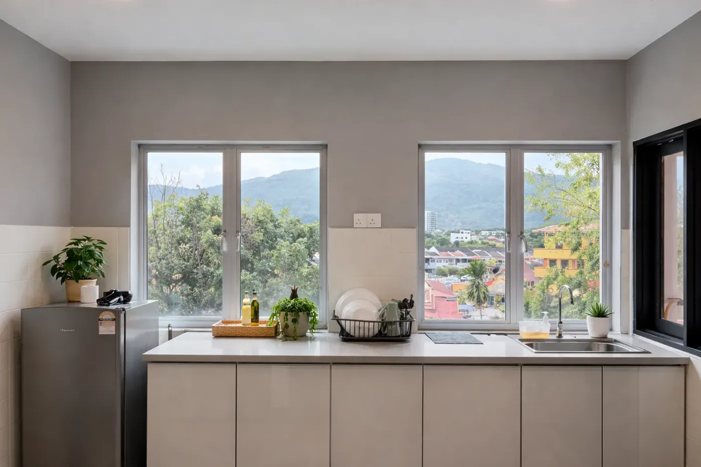 Modern kitchen with windows facing green hills