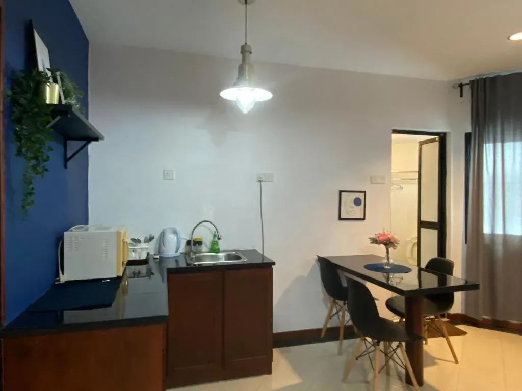 Kitchenette with microwave beside a small dining table