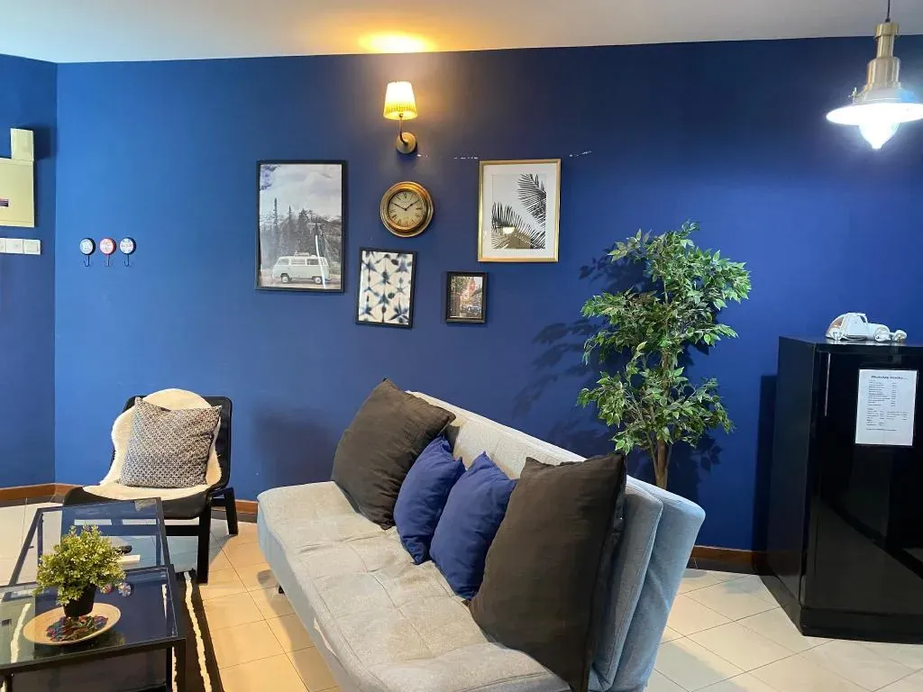 Blue living room with sofa and gallery wall