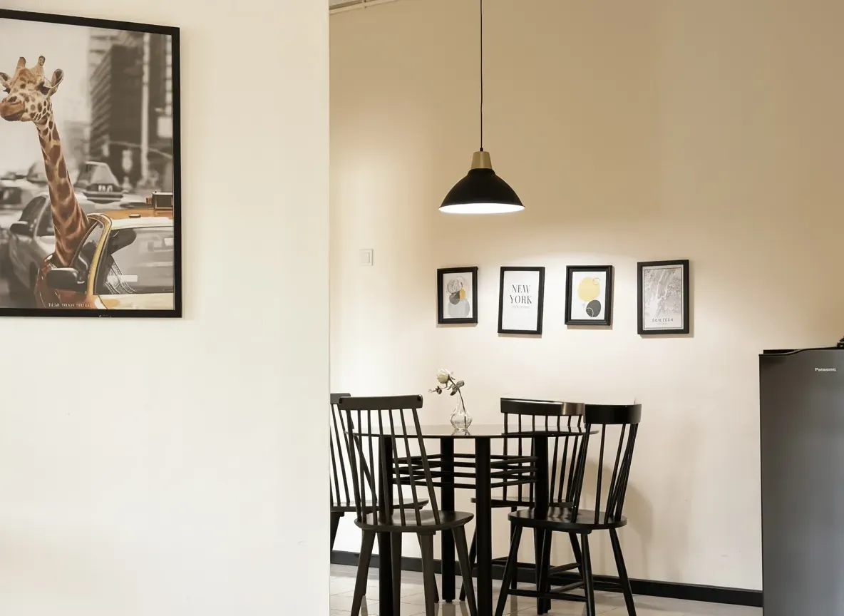 Dining table for four with framed prints