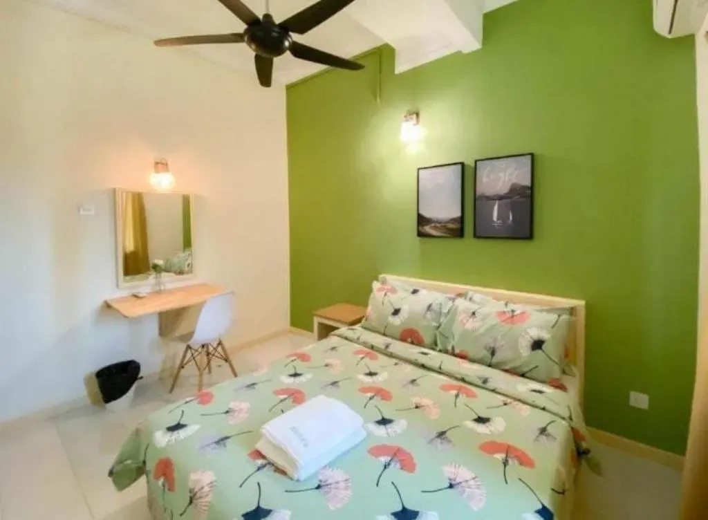 Bedroom with green feature wall and floral bedding
